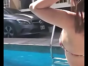 Swimming pool with a hot latina girl